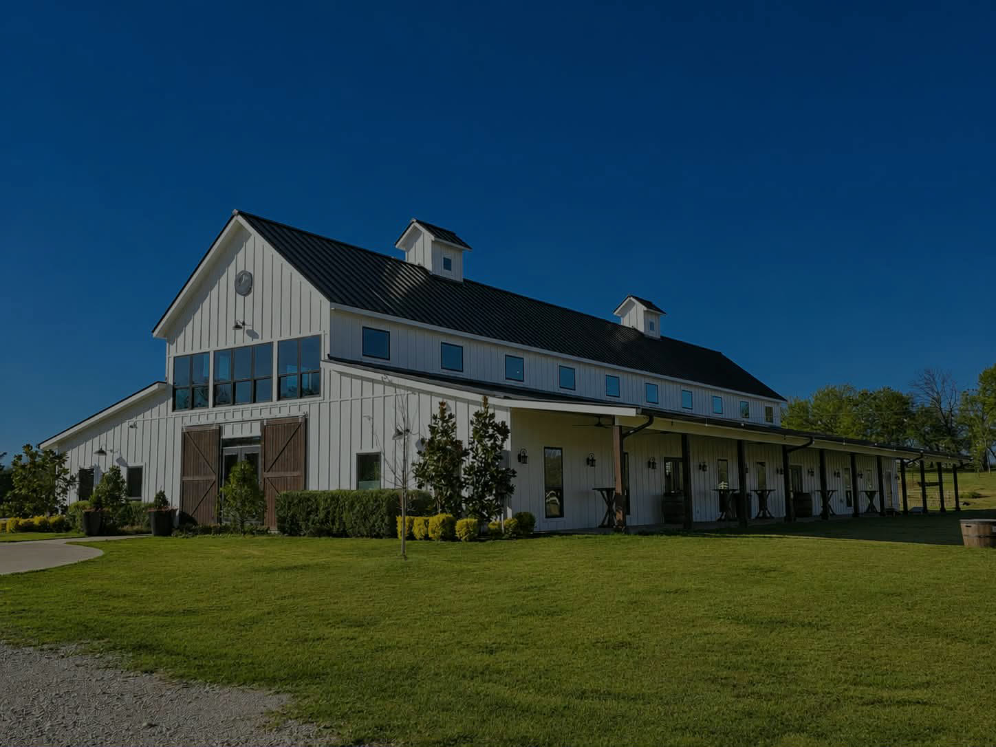The front of the Primrose Hill barn under a clear blue Texas sky